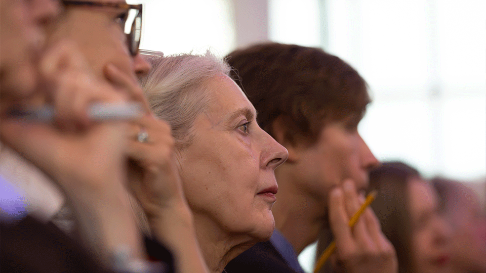 Photograph of audience members paying attention