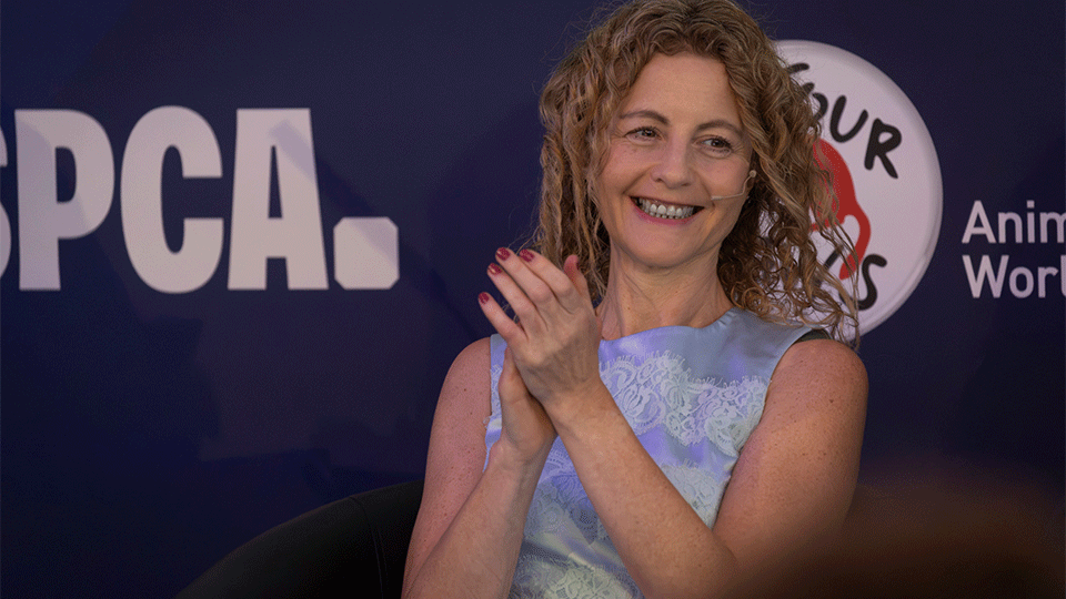 Photograph of Dr Jennifer Maher on the stage smiling